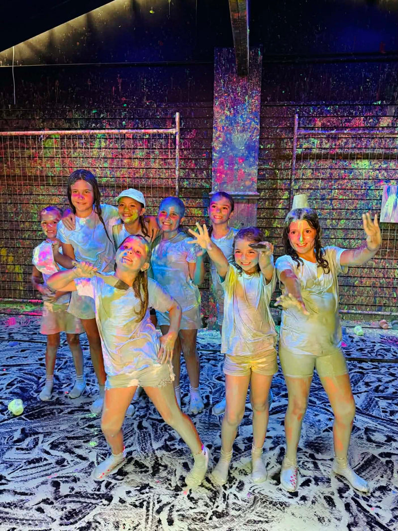 Group of kids in the splash room with colorful paints